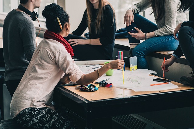 Group of people working a project at a table.