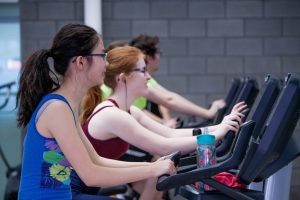 Two women on treadmills.