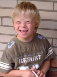 A photograph of a young boy with Down Syndrome.
