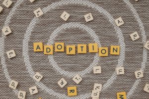 Scrabble tiles spelling out the world &quot;adoption.&quot;