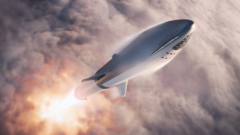 Artist's rendering of the SpaceX BFR rocket in flight just above the earth's atmosphere.