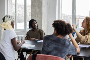 college students talking around a table