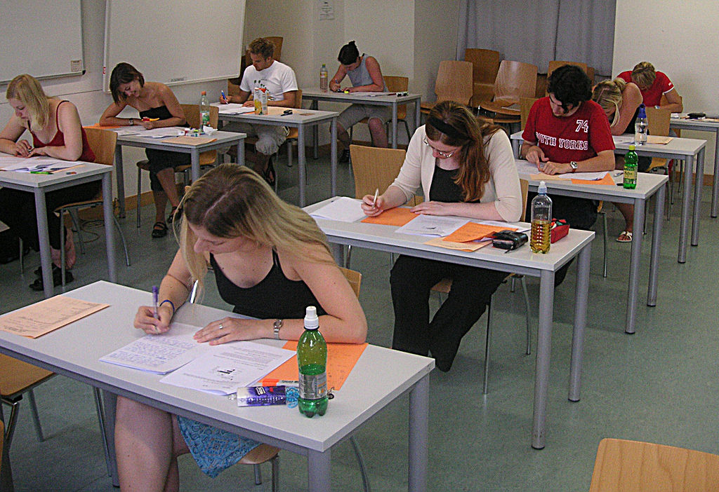 A classroom of students sitting at desks taking a test