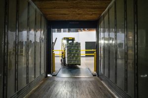forklift delivering stock to a warehouse.
