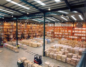 storage warehouse with pallet storage system, forklift in foreground