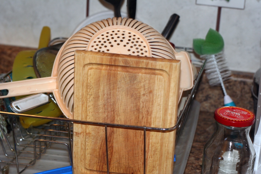 close up of dishes sitting in a drying rack