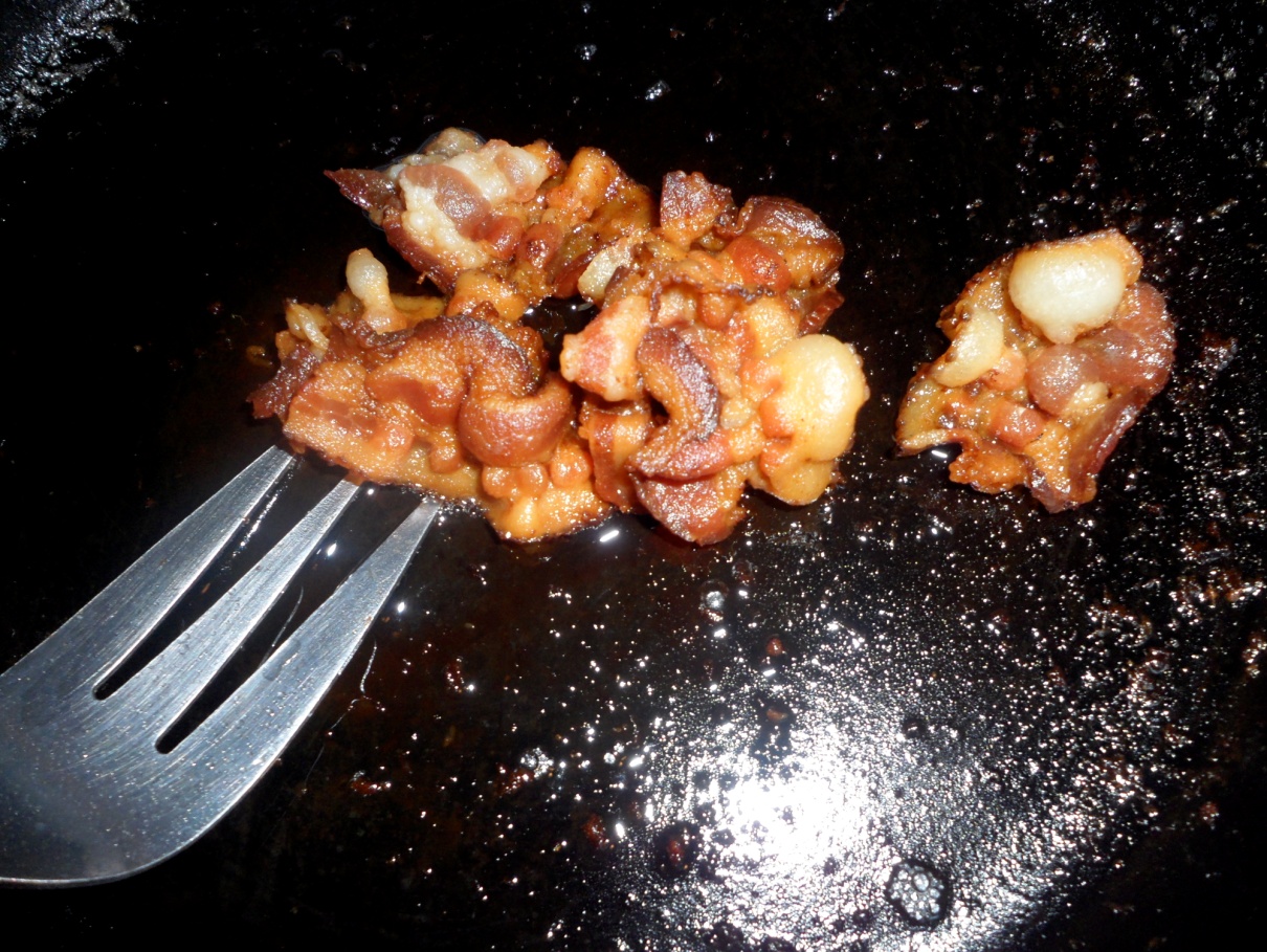 close up of bacon in a frying pan