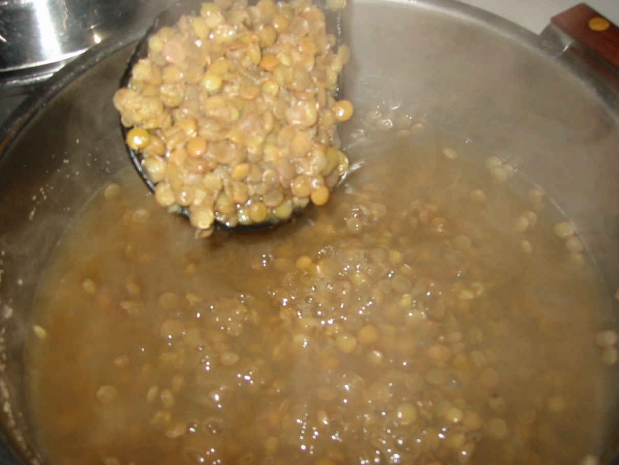 a pot full of cooking lentils