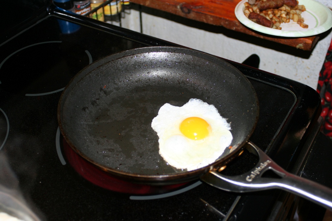 a fried egg in a frying pan on a stove