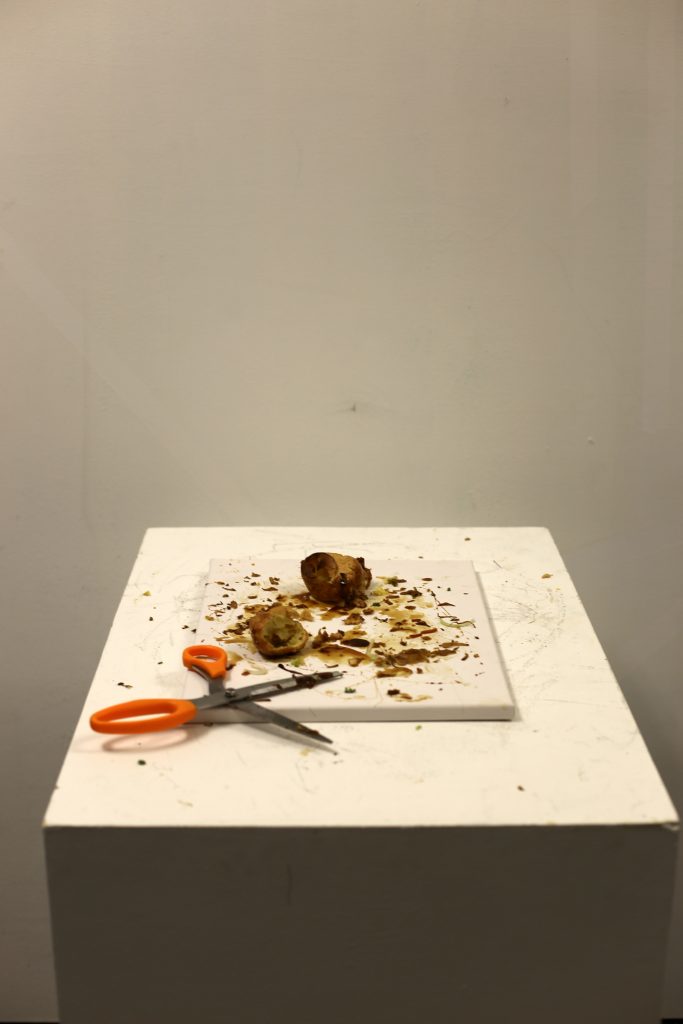 residue of the croquembouche, with scissors, on a gallery plinth
