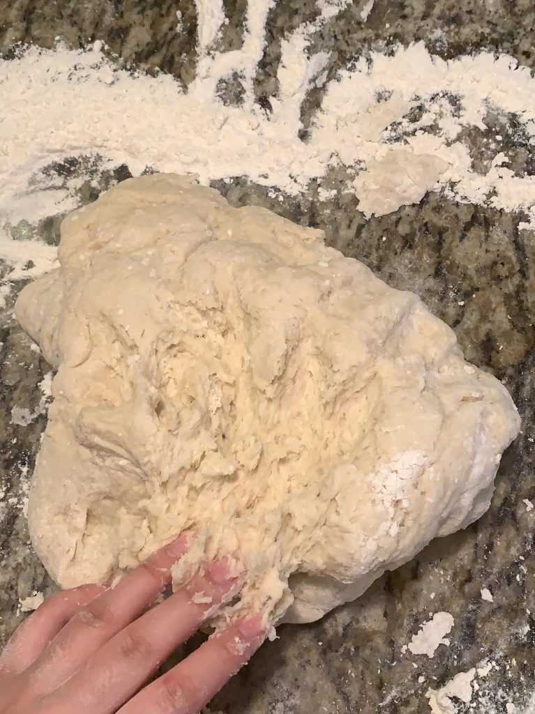 a hand touching dough for the project &quot;From Head to Dough&quot;