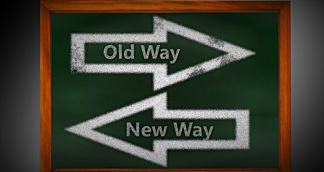 Board with arrows pointing left and right that say “old way” and “new way”