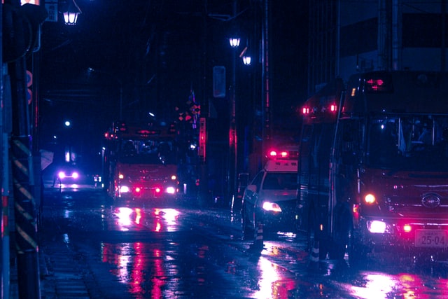 Dark street with the lights of emergency vehicles.