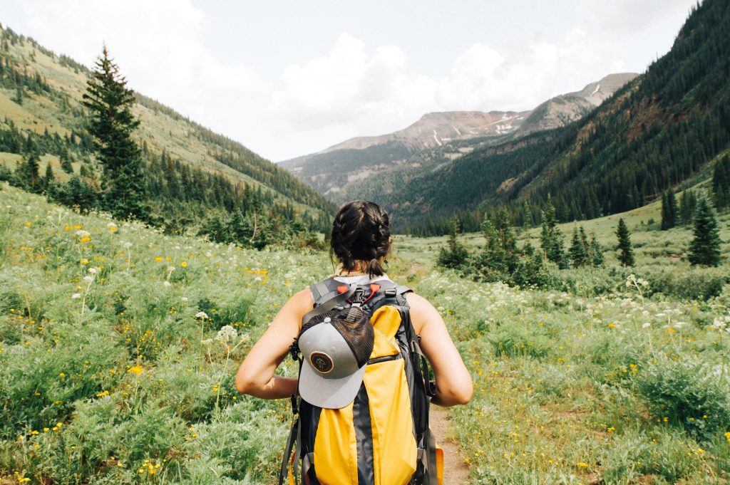 Person carrying a backpack, hiking in the mountains