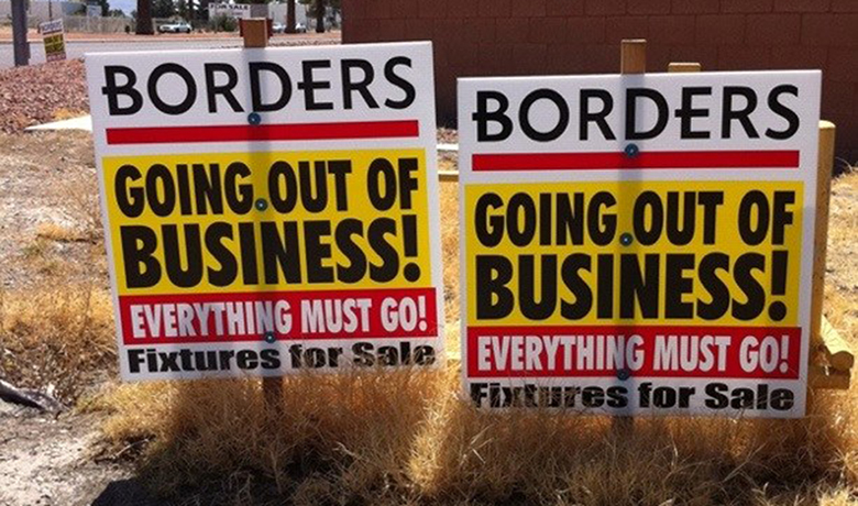 Photograph of a “Going Out of Business” signs for Borders. The signs denote that even the fixtures are for sale.