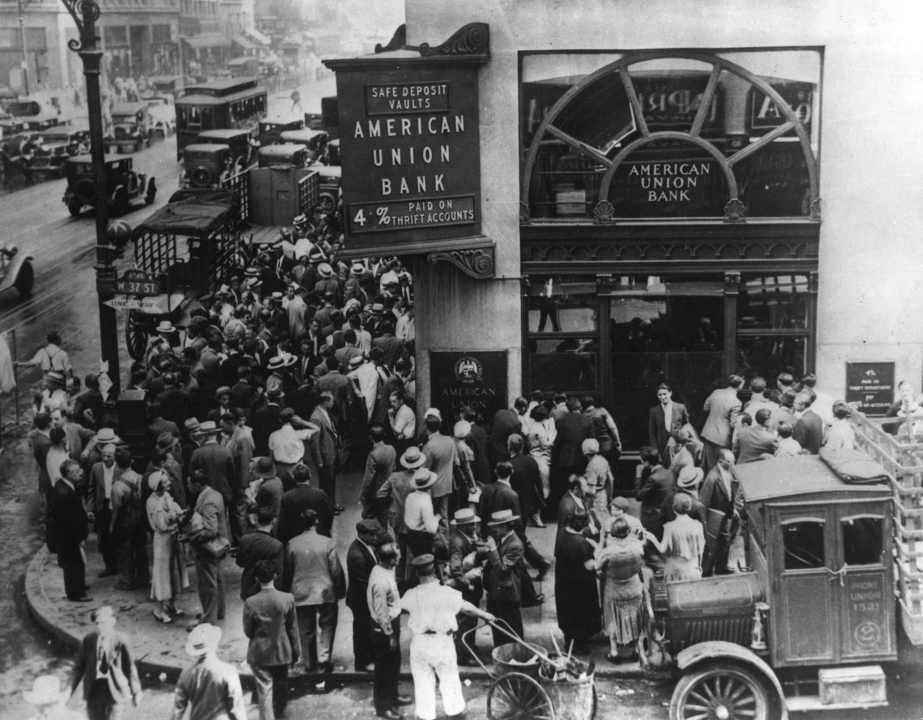 Image of crowd at New York's American Union Bank during a bank run early in the Great Depression. The Bank opened in 1917 and went out of business on June 30, 1931.