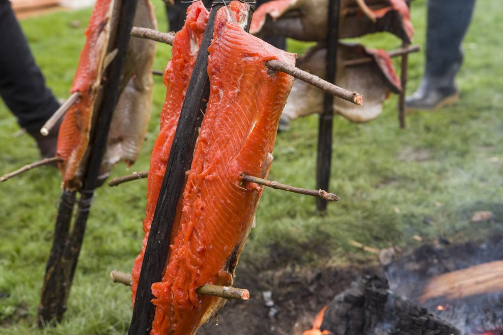 Salmon cooking in a pit
