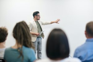 An individual speaking in front of people