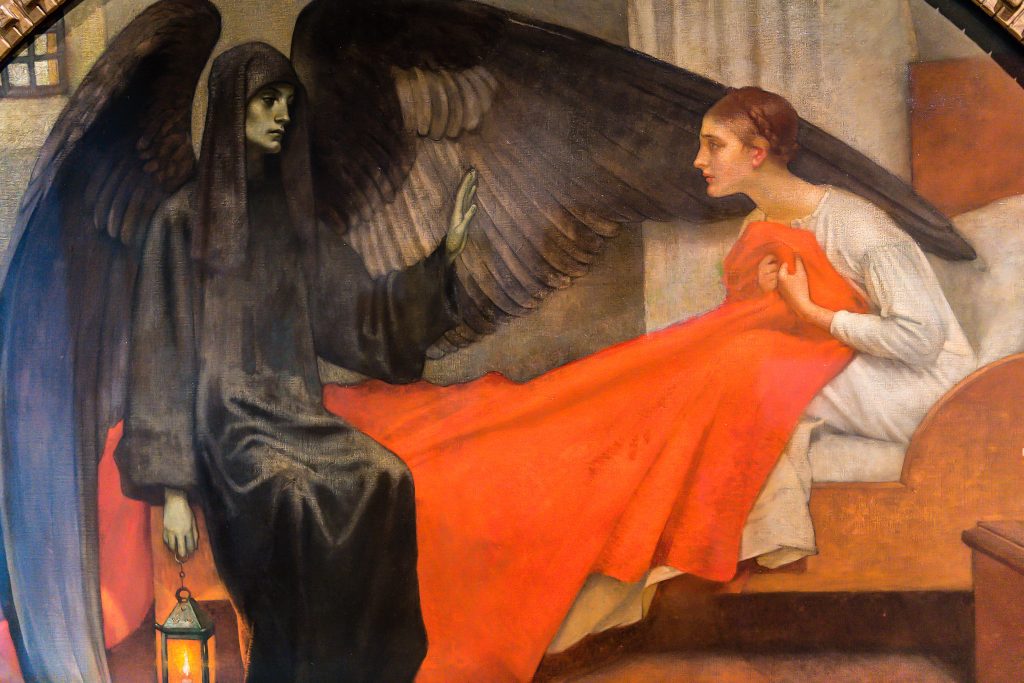 photo of painting titled Death and the Maiden, 1900, at the Speed Art Museum, University of Louisville, Louisville, KY. Death, an angel in black, speaks to a sick woman sitting in bed with a bright blanket.