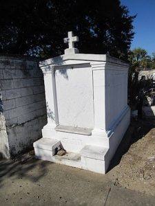 Tombstone with cross at Mount Olivet Cemetery in New Orleans, LA