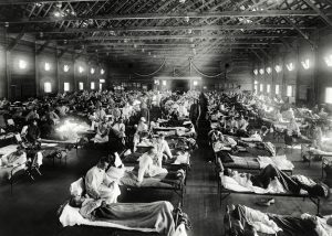 patients lying in beds in emergency hospital during influenza epidemic, Camp Funston, Kansas (1918). Original image from National Museum of Health and Medicine.