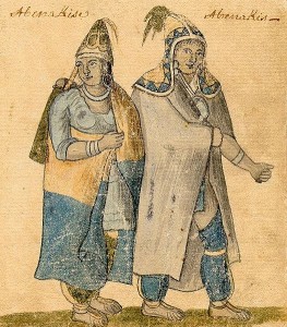 A man and a women wearing loose clothing, pointy hats, and blankets worn like capes.