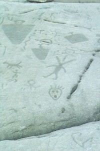 Numerous simple drawings on a rock's surface