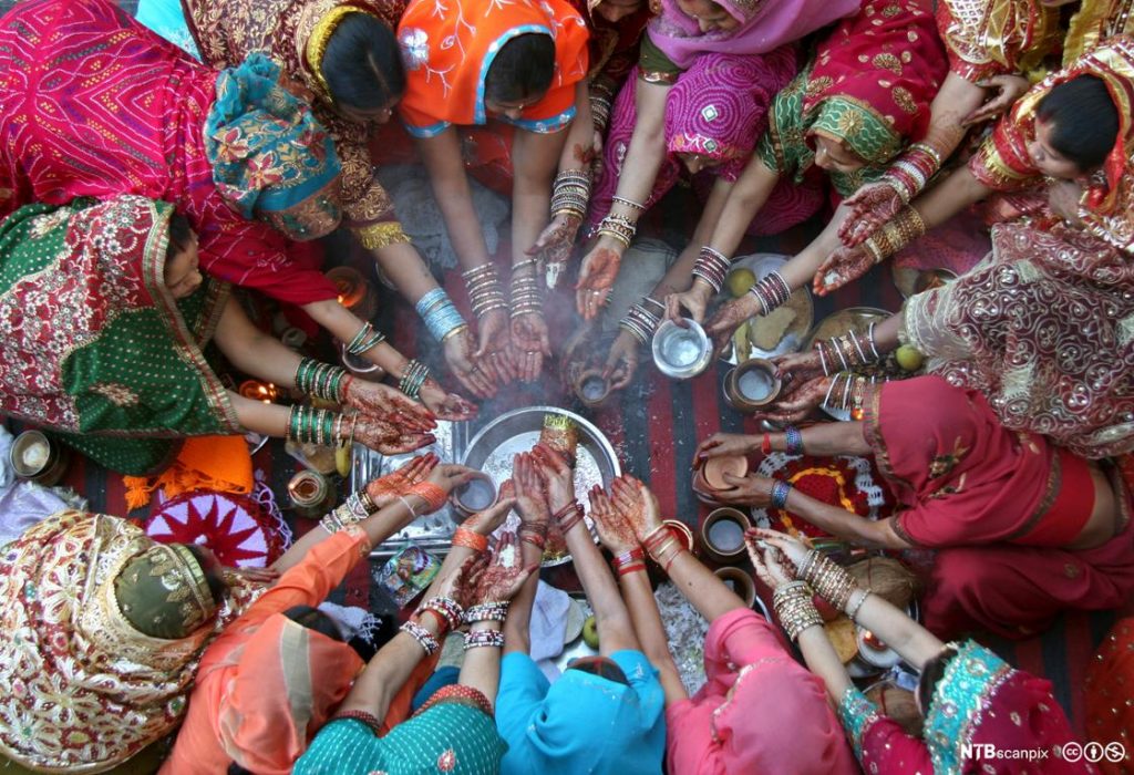 Women pray during the Hindu festival of Karva Chauth inside a temple in the northern Indian city of Chandigarh