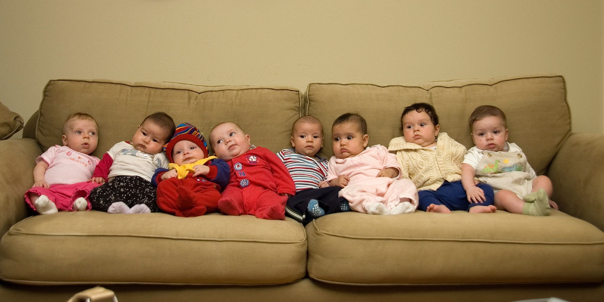 A group of babies on a couch