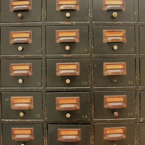 A series of 15 files drawers, similar to a old library card catalogue