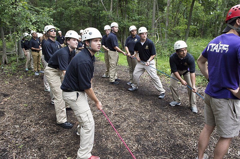 Two teams of law enforcement explorers pulling a rope.