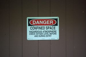 Sign that states: Danger confined space - hazardous atmosphere - check oxygen level before and during entry
