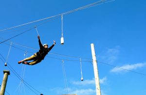 woman executing a trust dive on a High Ropes course