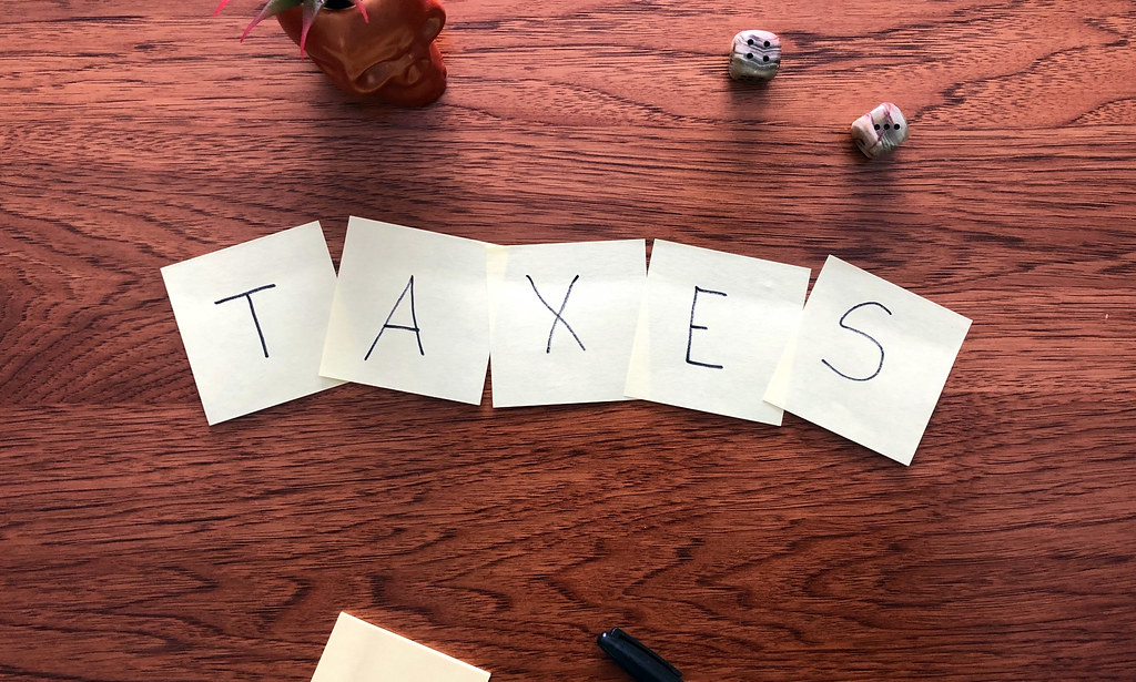 Photo with sticky notes that say Taxes