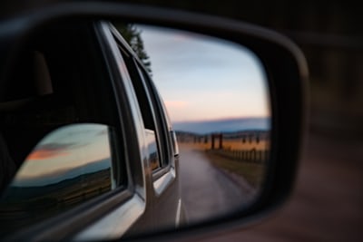 Photo of the perspective in a car's rearview mirror.