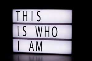 A photo of a sign that says- this is who I am