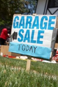 Garage sale sign reading garage sale today with a black arrow pointing.