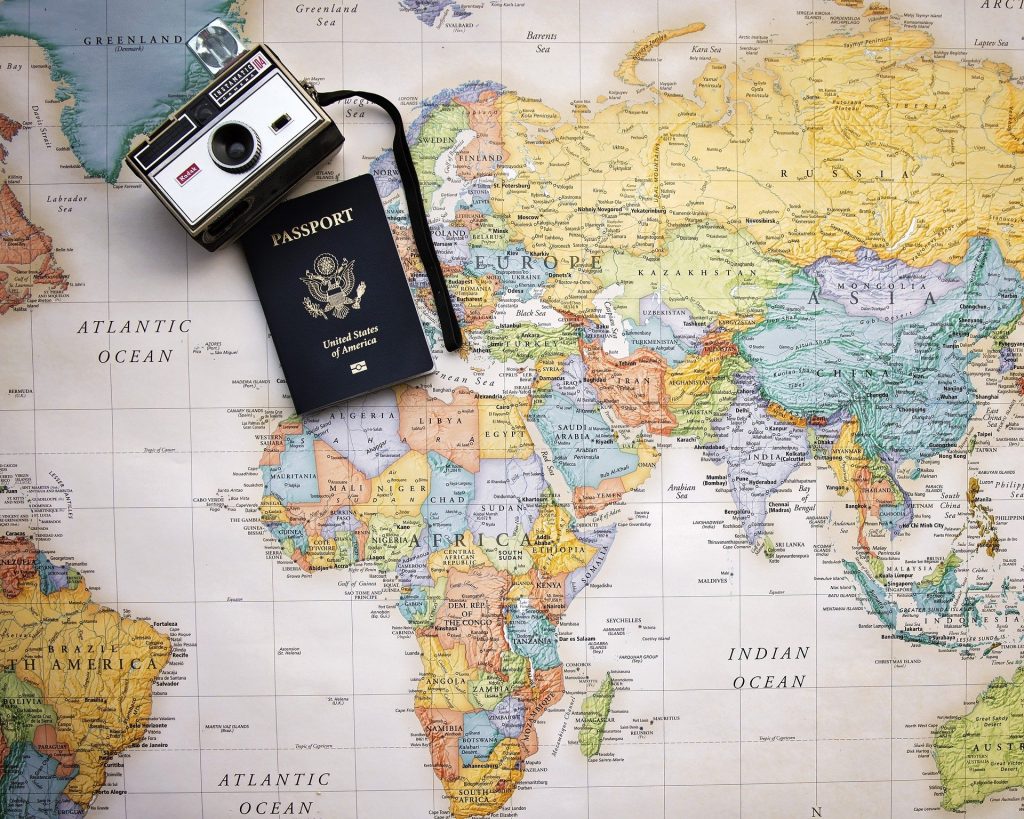 map, camera and passport