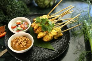 satay skewers with sides on a plate