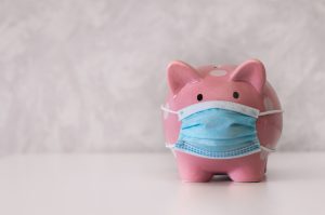 Photo of a piggy bank wearing a mask