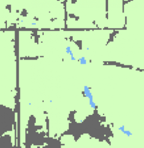 A screenshot of a map. Most of the map is pale green, but pixelated areas of grey and blue are also visible.