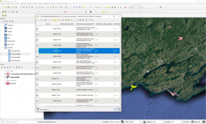 QGIS, showing the attribute table for a shapefile of Ontario provincial parks; the row for Presqu'ile provincial park is highlighted. In the background, a map of these parks is visible; most are pink, but Presqu'ile is highlighted in yellow.