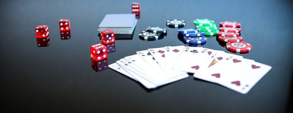 Gambling chips, dice, and playing cards on a casino table