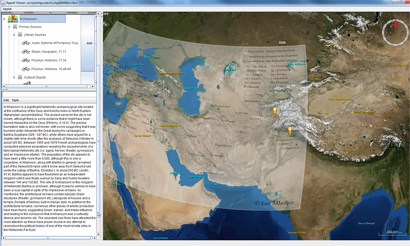 This image shows a web-based interface for a 3D geographic information system, displayed in a browser window.  The left third of the window is a panel consisting of selection items at the top, and a detailed description of the user’s selection, “Al Khanoum”, at the bottom of the panel.  The left two-thirds of the window shows a detailed relief map of the ancient Seleucid Empire in Central Asia.  A political map showing cities of the ancient Seleucid Empire is superimposed as a translucent layer atop the 3D relief map.  A compass pointing north is shown in the upper right corner of the window.