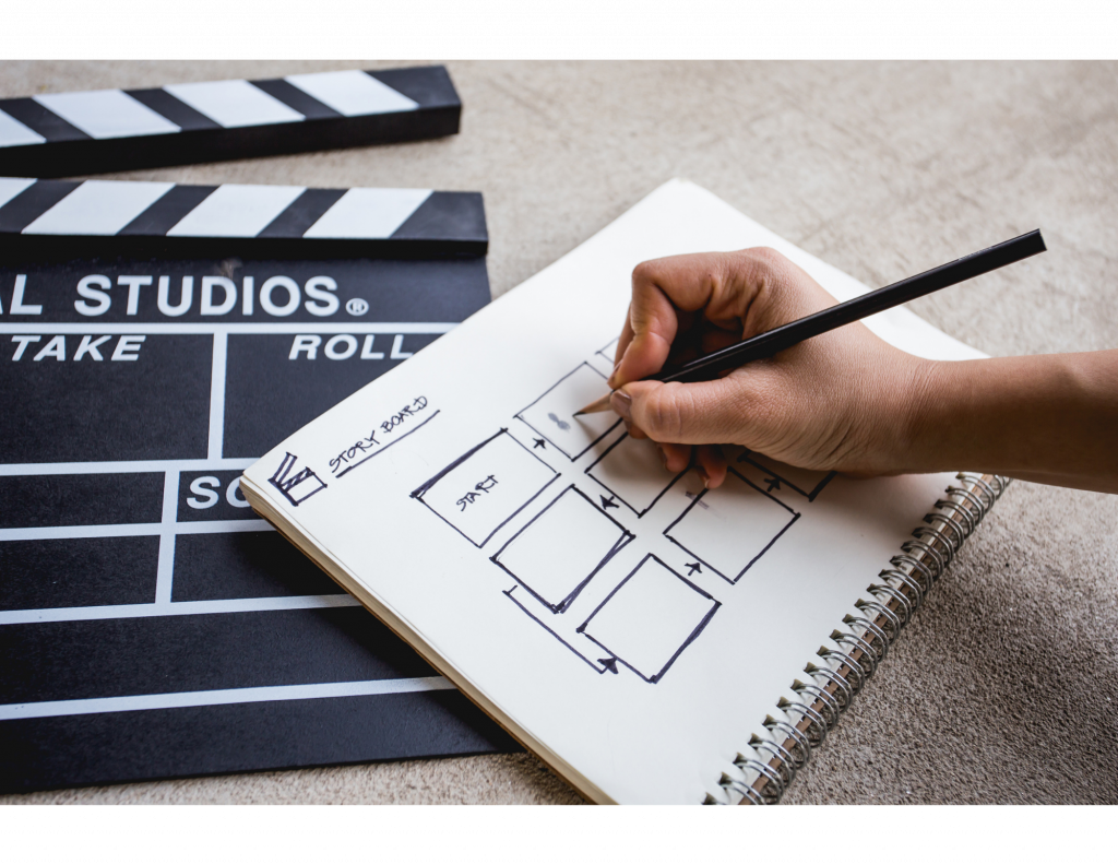 A person using a pen and paper to create a storyboard