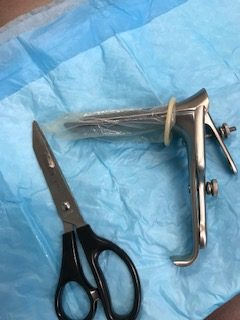 Speculum with condom over top and tip cut off to assist with exam of individuals with high BMI