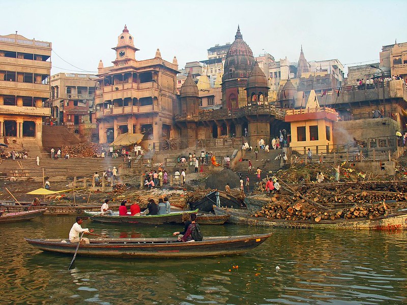Hindu Minikarnika cremation ghat in Varanasi, with people in row boats