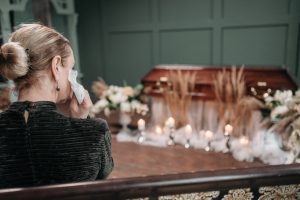 a woman at a funeral sitting on a hair