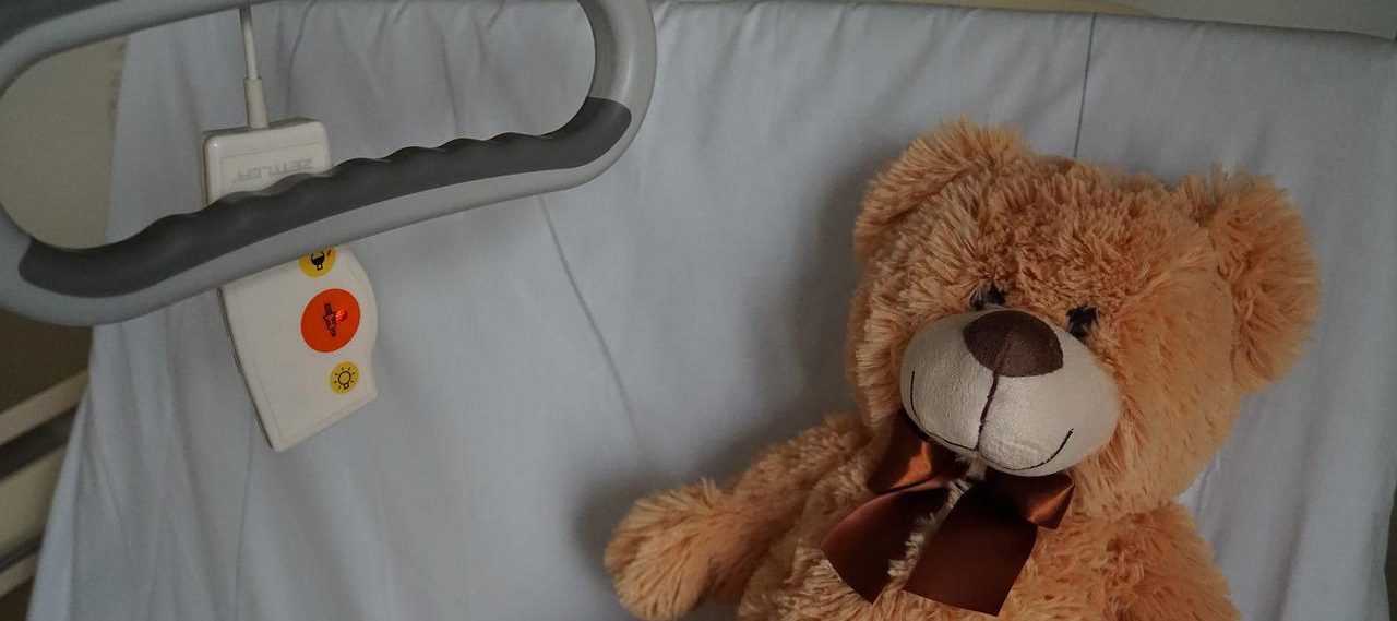Teddy bear on a hospital bed
