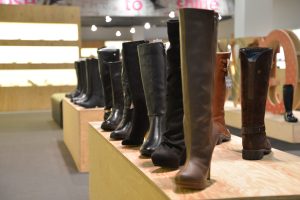 An image with boots and shoes on display